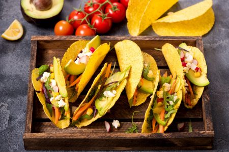 Vegetarian tacos, healthy mexican snack, tortillas with avocado, cheese and veggies